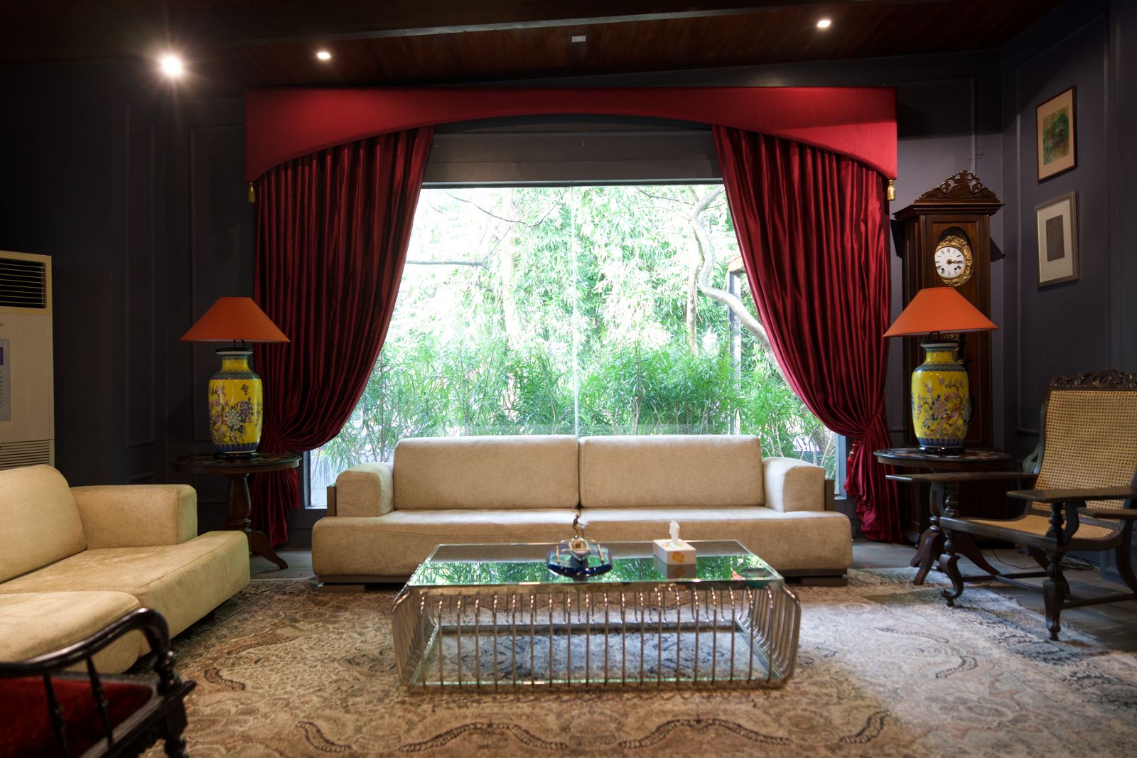 Living room with deep red floor-length drapery panels and matching valance board.